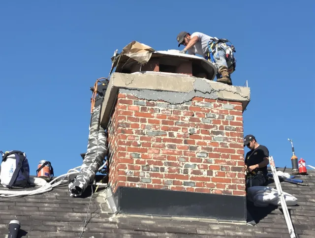 North Castle Chimney Sweep installing a custom chimney crown in North Castle, NY