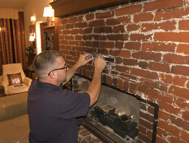 North Castle Chimney Sweep expert fixing a fireplace in North Castle, NY